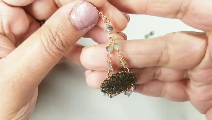 Create the basic wire wrap for each bead. Leave about half an inch of wire, make a loop with six-step looping pliers, wrap two to three times around the bead, and tuck in the end.