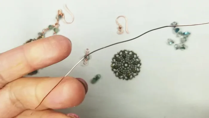 Attach the second 4mm round bead using the same wire wrapping technique.