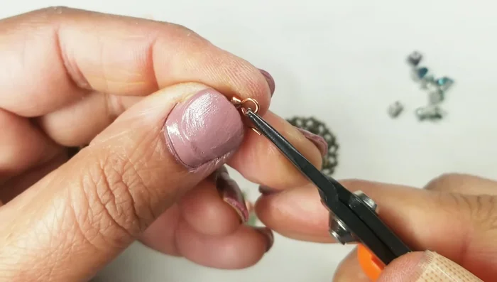 Attach the ear wire to the trapezoid crystal and close it securely.