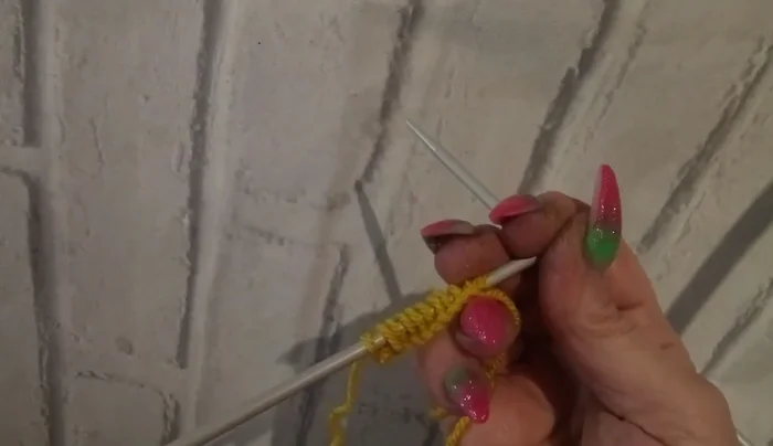 Knit a pearl row to spread out the increased stitches.