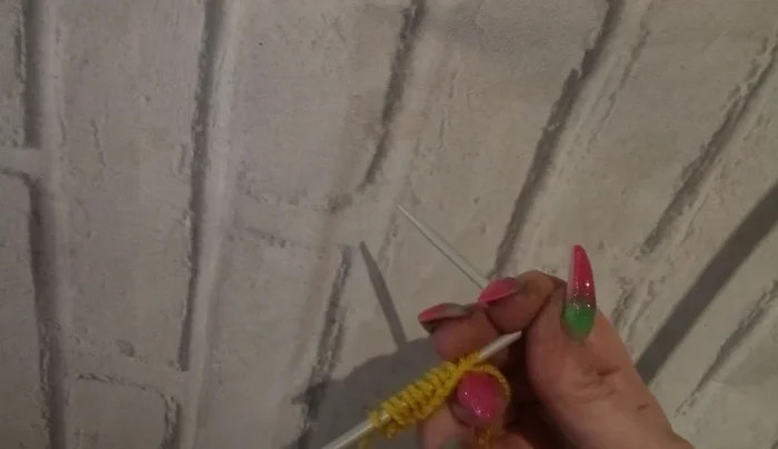 Knit a pearl row to spread out the increased stitches.