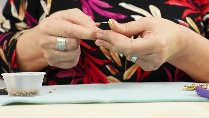 Secure the beading wire: Wrap the beading wire around the hoop base several times on both sides to secure it. Trim and pinch the wire ends.