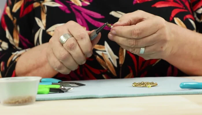 Attach the link and ear wire: Open the loop on the eye pin and attach it to the top of the earring hoop. Attach the ear wires.