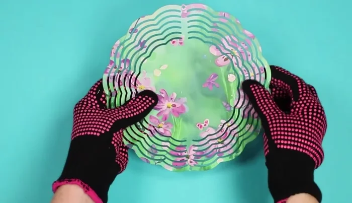 Assemble the wind spinner: Gently bend and shape the metal layers to create the desired fanning effect. Adjust until satisfied with the look.