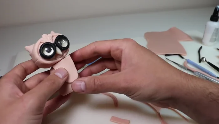 Create and attach a leather breastplate with stitching details.