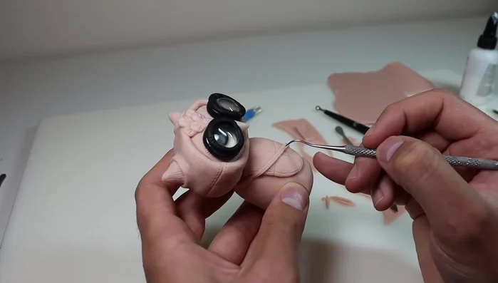 Create and attach a small backpack with straps and a clasp.