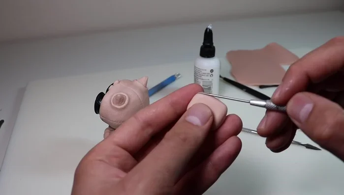 Create and attach a larger backpack to the back of the owl with straps and seams.