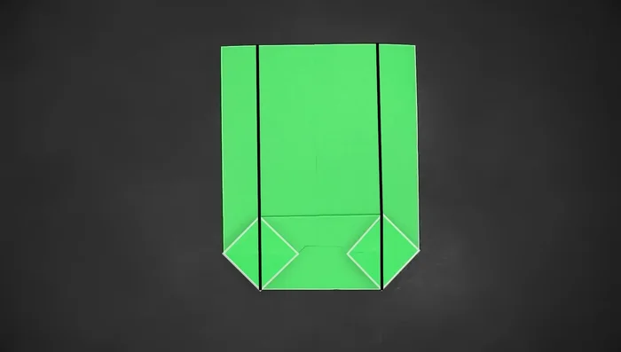 Fold the two bottom side using the corners of the small squares as guides.