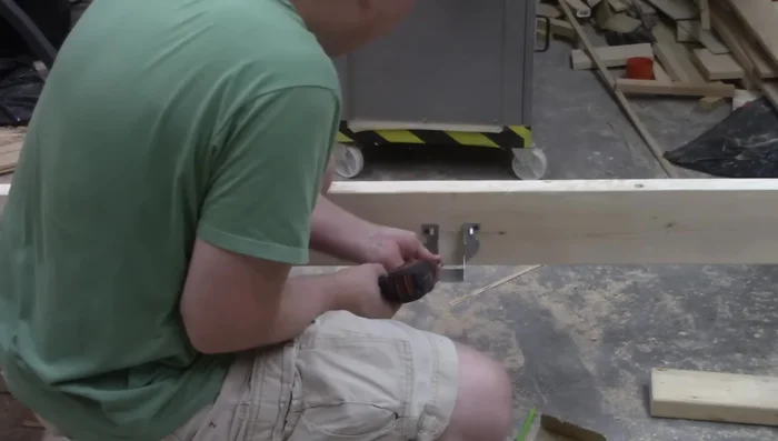 Cut the center support rail to fit within the Raptor hangers.