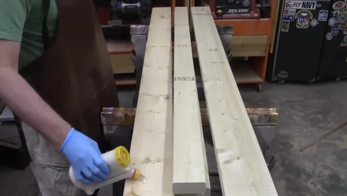 Center and glue the 74-inch 2x4s onto the 84-inch 2x6s to create the left and right rails.