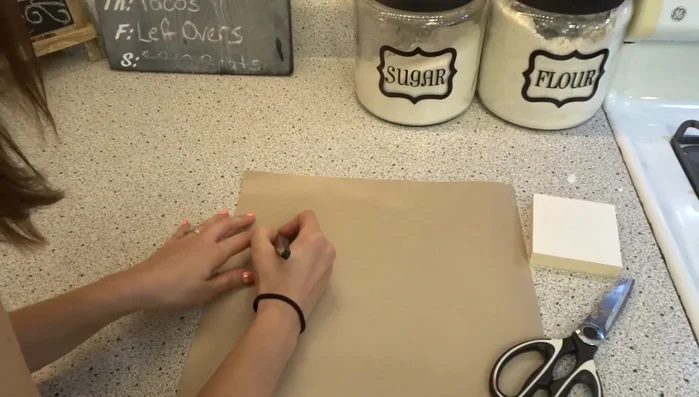 Weed the contact paper, carefully removing the negative space around your design using the weeding tool and scissors. Ensure a border remains.