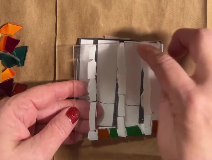 Continue adding glass pieces, ensuring all edges are flush against the acrylic base.