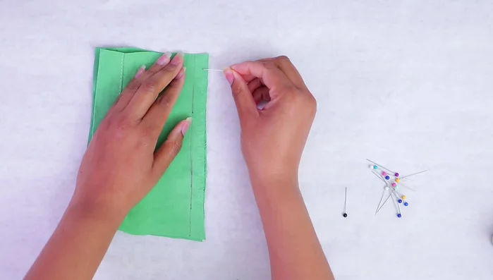 For curves, add more pins to maintain fabric alignment.