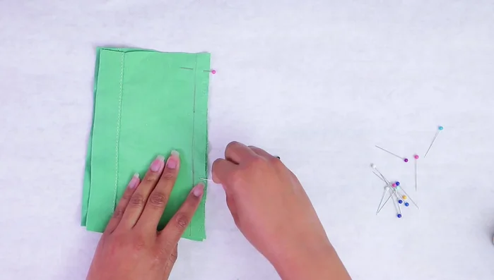 For curves, add more pins to maintain fabric alignment.