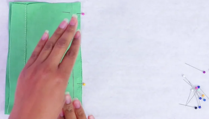 For curves, add more pins to maintain fabric alignment.