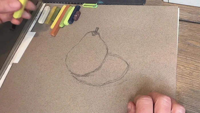Sketch the pear shape lightly with a charcoal pencil.