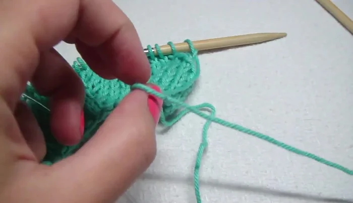 Change yarn color: Cut yarn, leaving enough tail to weave in later. Create a loop with the new color, knit the first stitch with the new yarn.