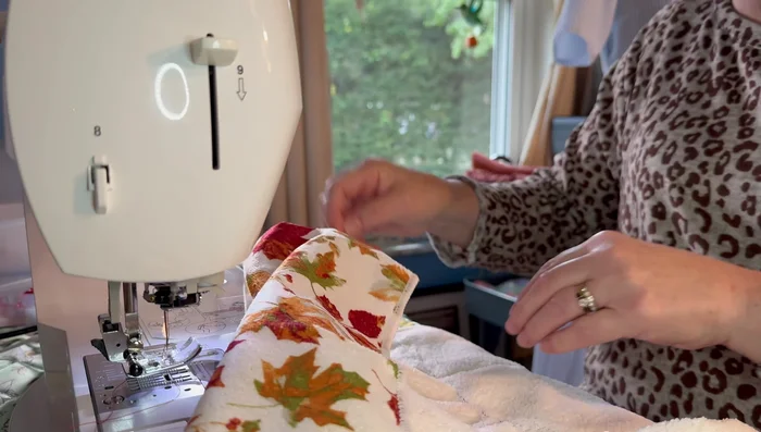 Pull the gathering threads to gather the towel to the desired length, matching the length of your pot holder.