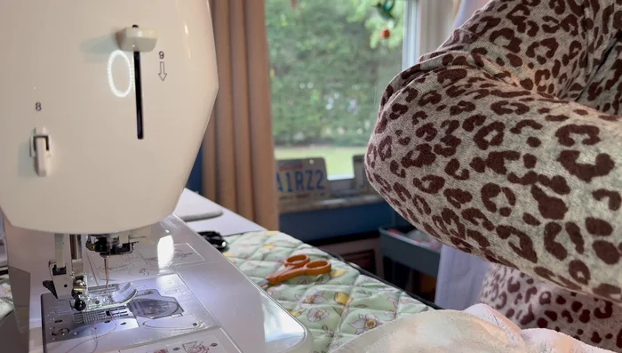 Sew the pot holder onto the towel along its edge, using a backstitch for security.