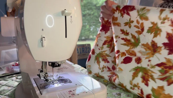 Pull the gathering threads to gather the towel to the desired length, matching the length of your pot holder.