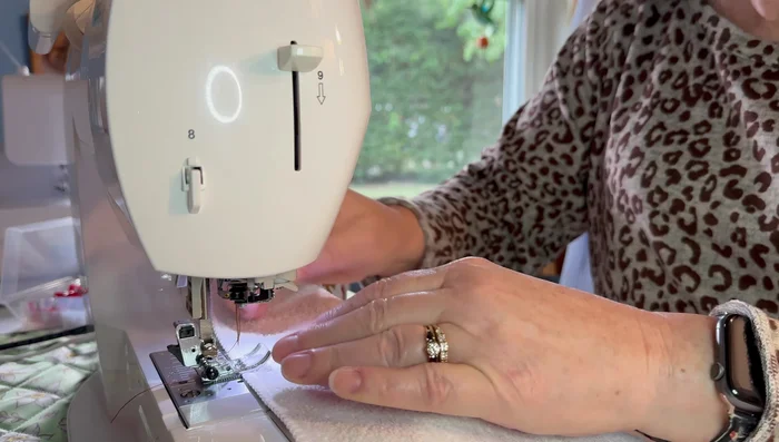 Pull the gathering threads to gather the towel to the desired length, matching the length of your pot holder.