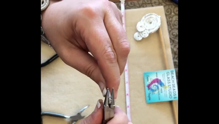 Continue rolling and flattening the wires, creating a swirl pattern. Keep pulling on both sides to maintain a flat shape.