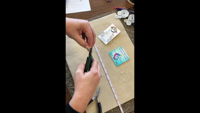 Trim the excess wire, leaving about an inch from the top of the swirls. Shape the bottom loop using round nose pliers and bench block.