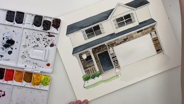 Painting the lawn with a soft green wash, blending edges for a natural look.