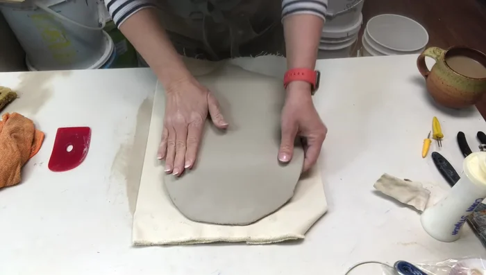 Trimming excess clay and making the edges even.