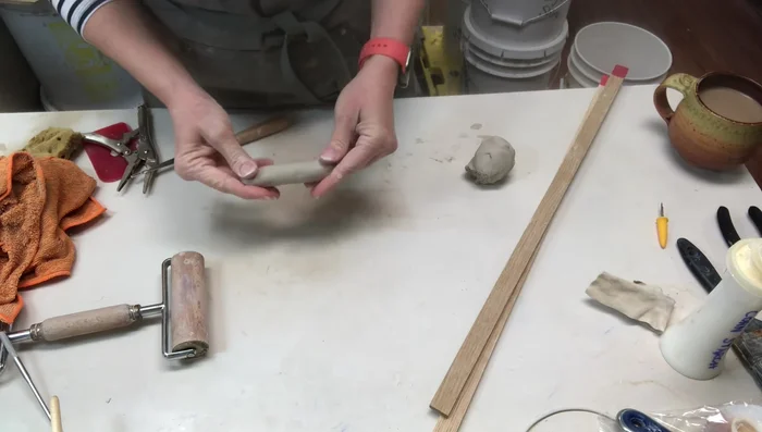 Creating handles (optional) by making coils, flattening and shaping them, and adding texture.