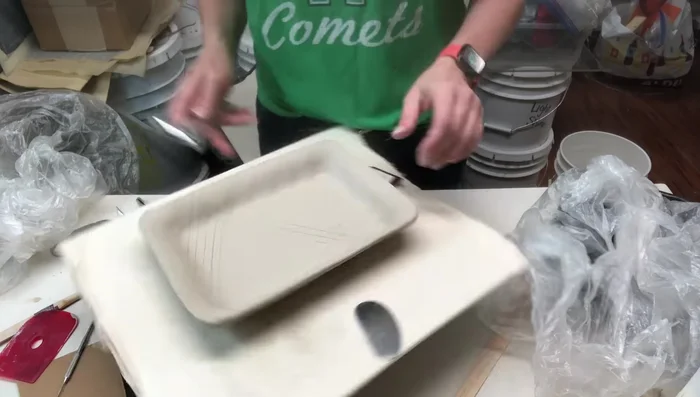 Rounding and smoothing the edges using a rib, notch strip, or vegetable peeler, then compressing with wet fingers.