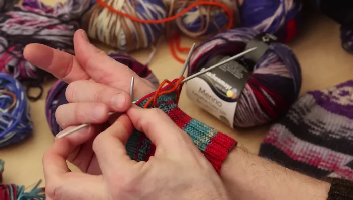 Increase stitches on either side of the marked thumb stitches until you have nine stitches for the thumb (adjust based on thumb size).