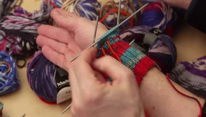 Increase stitches on either side of the marked thumb stitches until you have nine stitches for the thumb (adjust based on thumb size).