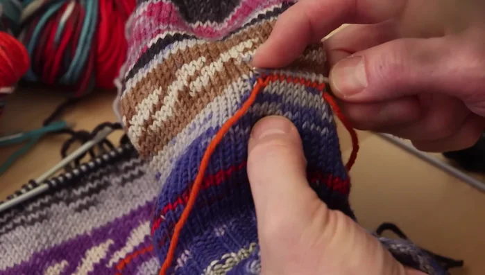 Divide the picked-up thumb stitches onto four needles.