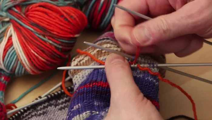 Knit the thumb, adjusting the length as needed. Decrease stitches at the beginning and end of the thumb to shape it.