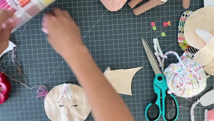 Cut out two ear pieces from doubled fabric, sew them (leaving a small opening), clip the curves, turn right side out, and press flat.