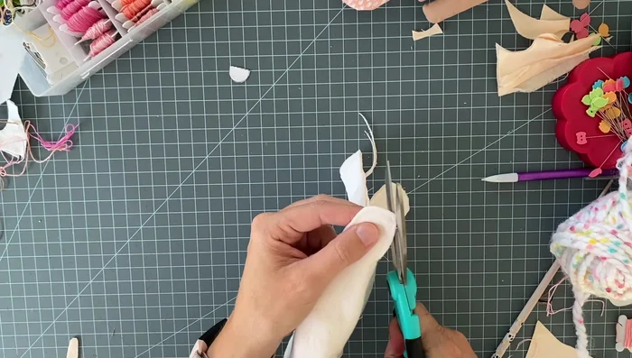 Trim the seam allowance close to the stitching, clip curves and corners to allow for easier turning.