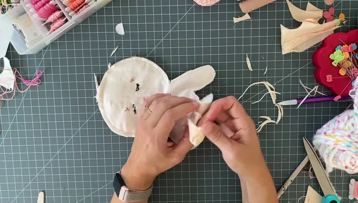 Stuff the doll very firmly with polyfill. Use hemostats or other tools to push the stuffing into tight areas. 