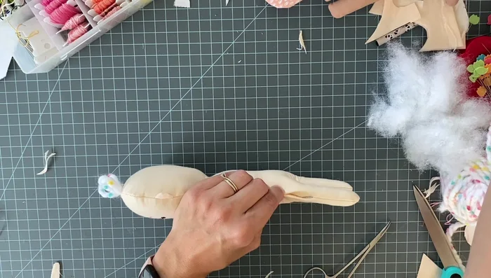 Hand stitch the opening closed, and add a ribbon bow to the hair.