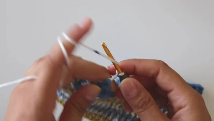 Work four rows with the multicolor yarn.