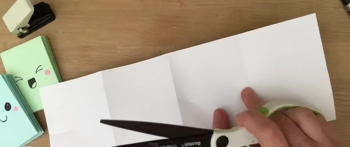 Open up the paper and cut along the center line of the two middle sections. (You can tear instead of cutting if your creases are sharp).