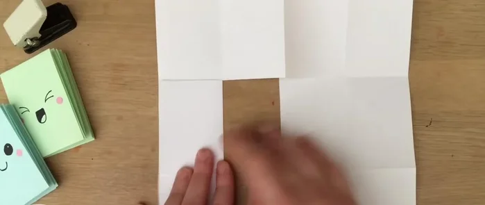 Open the folded sections, push the edges together, fold down, and make your creases. You should now have eight pages.