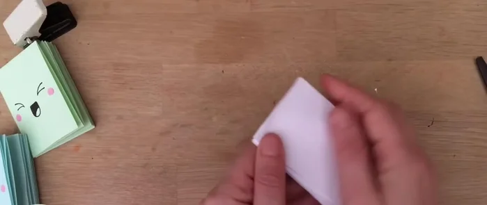 Open the folded sections, push the edges together, fold down, and make your creases. You should now have eight pages.