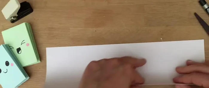 Fold the paper over again.