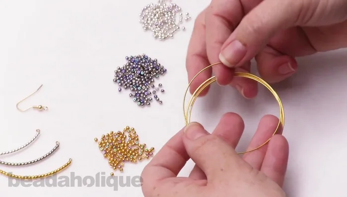 Cut a piece of memory wire, leaving enough length for a loop and the desired bead length.