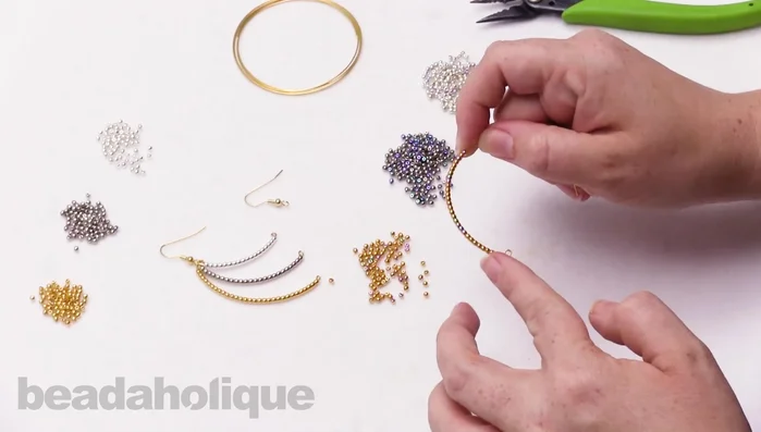 Cut the excess wire using memory wire cutters. Ensure you leave enough wire for another loop.