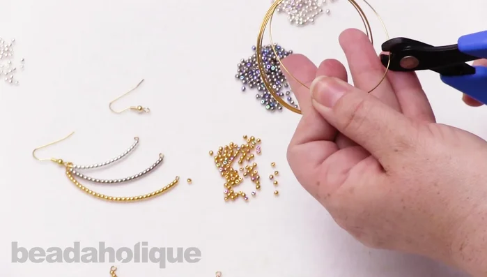 Repeat steps 1-7 to create two more earring pieces with varying bead lengths and colors.