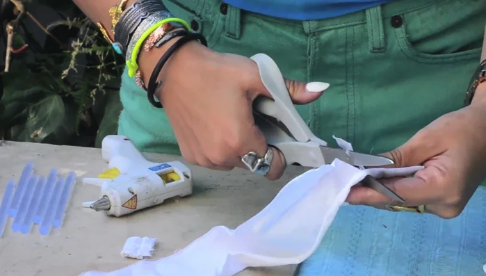 Create flower buds: Apply hot glue to the center of each square and fold to create a bud. Make many buds.