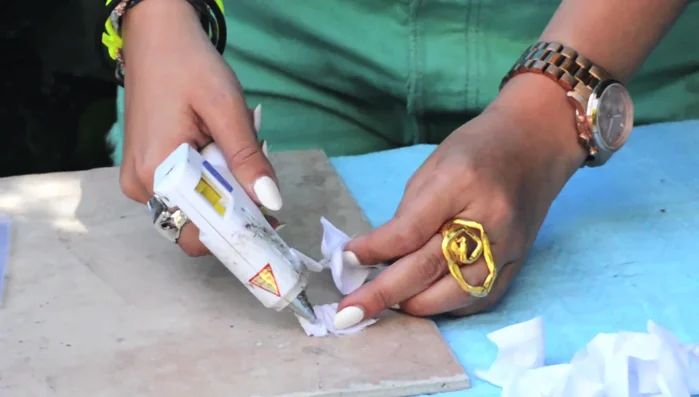 Assemble the first flower type: Glue the buds onto a base cut from the sheet, creating a clustered flower.
