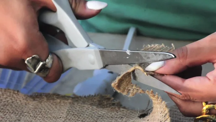 Create spiral flowers: Cut a circle from thicker fabric (burlap/felt). Spiral lace or fabric around the circle using glue, trimming the ends.